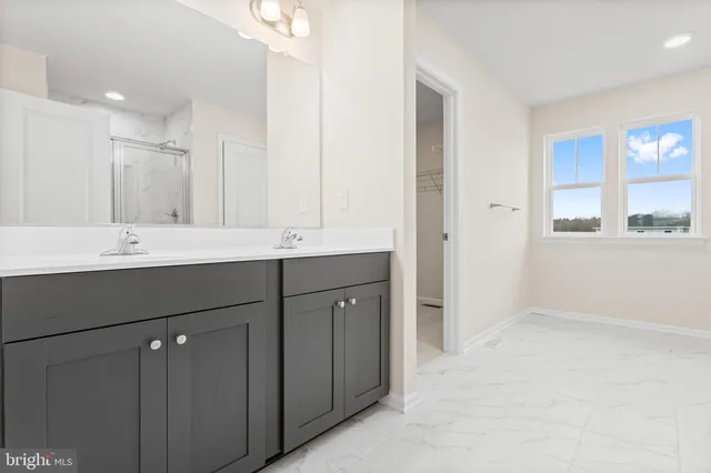 a bathroom with a double vanity sink and mirror