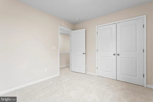 an empty room with closet area