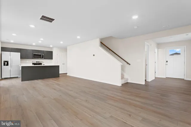 a view of kitchen with wooden floor and electronic appliances