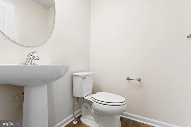 a bathroom with a sink a toilet and mirror
