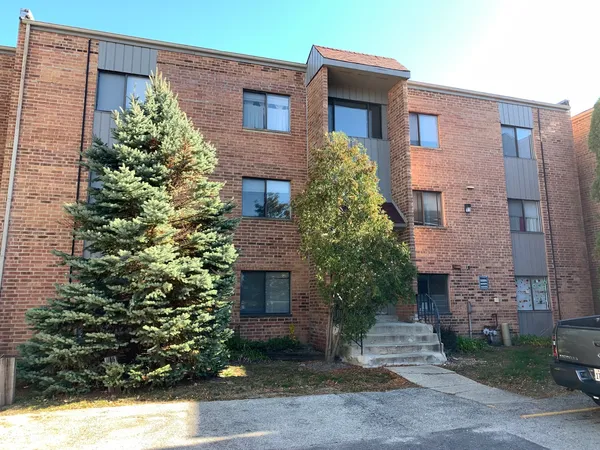 a front view of a house with plants