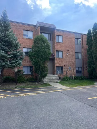 a view of a brick building next to a yard