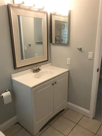 a bathroom with a sink vanity and mirror