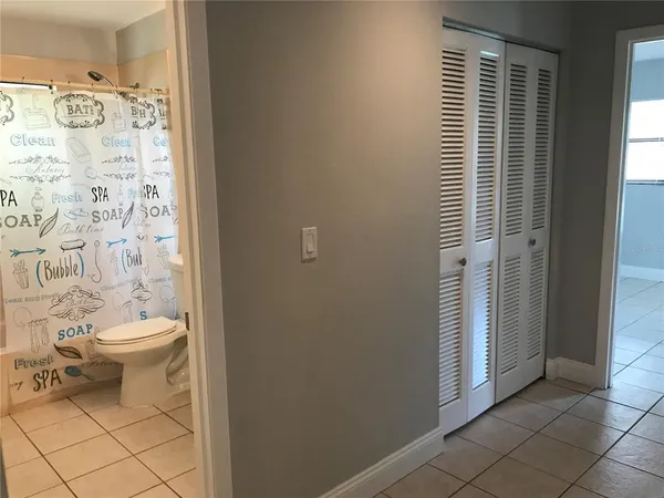 a bathroom with a toilet and a shower curtain