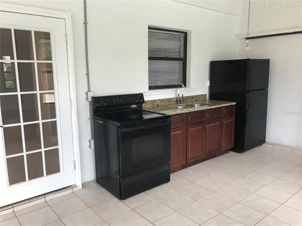 a kitchen with a sink and a refrigerator