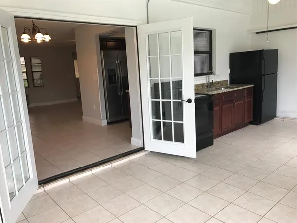 a view of a kitchen with refrigerator and mirror