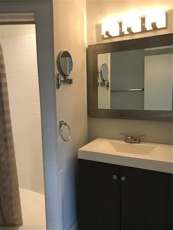 a bathroom with a sink and a mirror