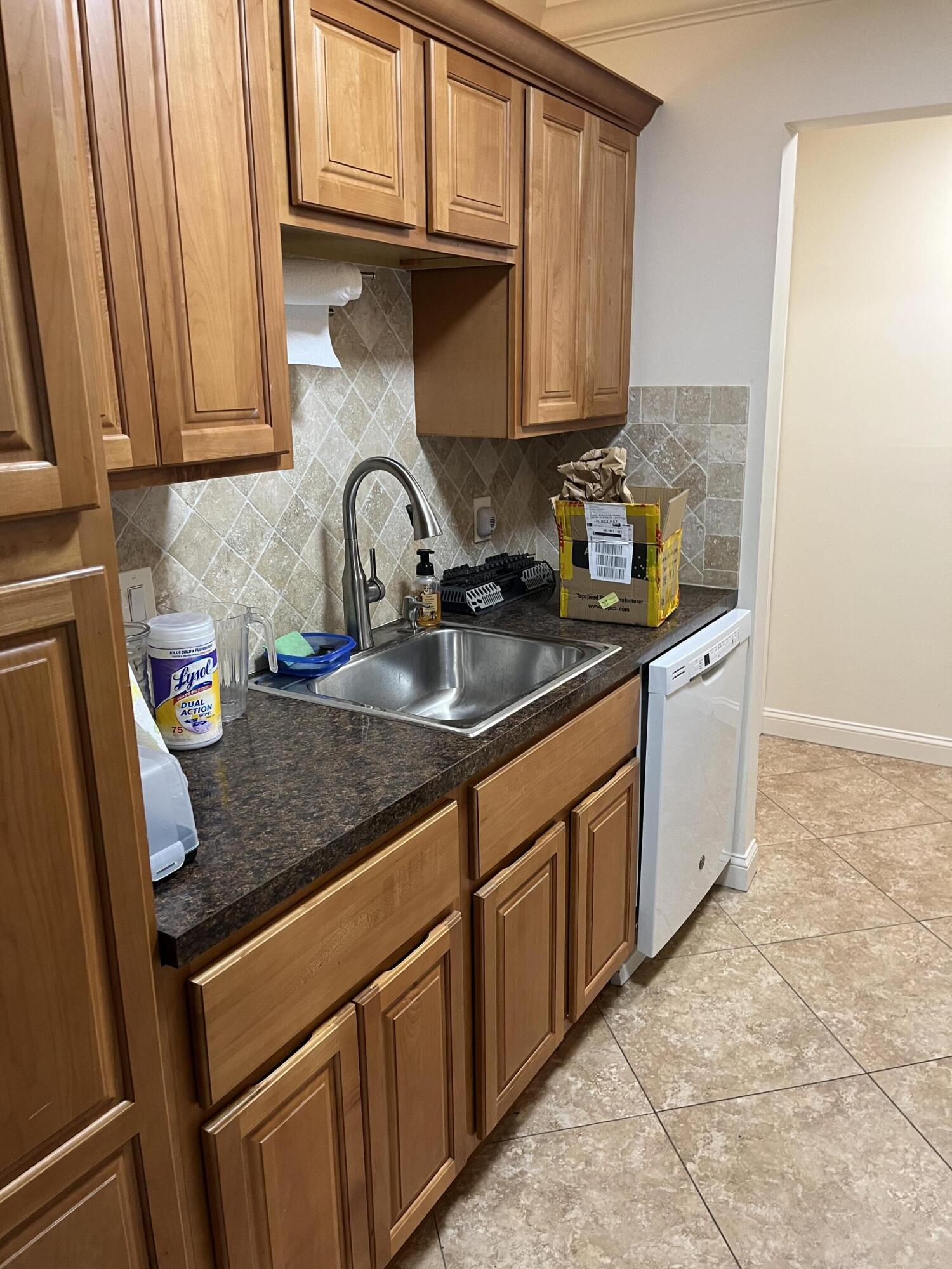 150 Pineview Road, Unit B7 Jupiter, FL 33469 - Photo 11 of 11 a kitchen with stainless steel appliances granite countertop a sink and cabinets