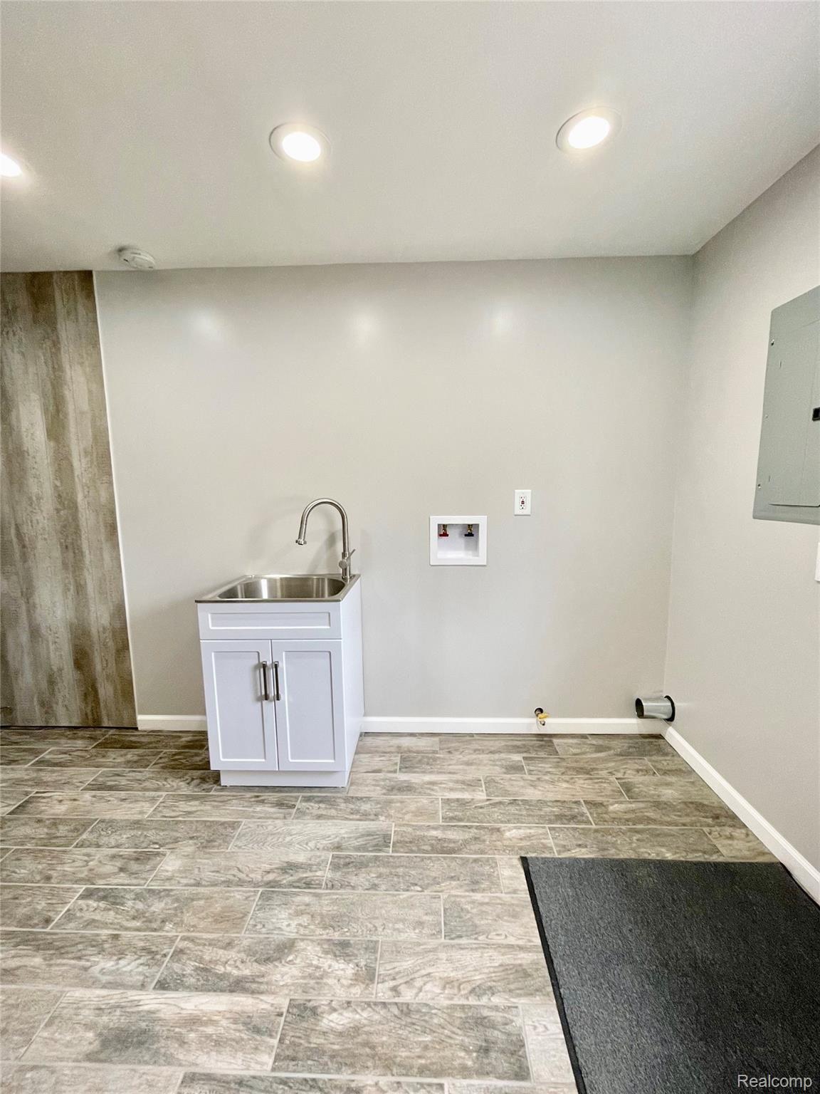 9089 Beech Daly Road Taylor, MI 48180 - Photo 31 of 42 Laundry area in utility room. Porcelain tile, recessed LED lights.