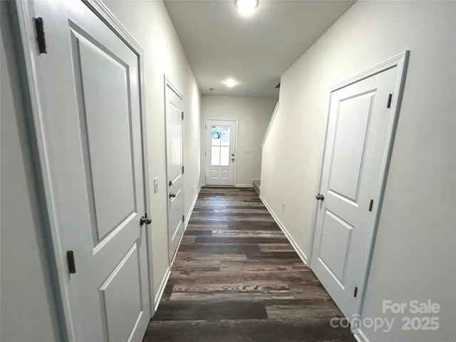 a view of a hallway with a white walls and stairs