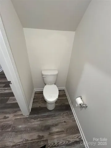 a bathroom with a toilet and a mirror