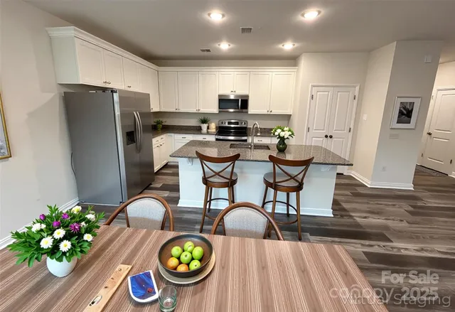 a view of kitchen with dining table and chairs