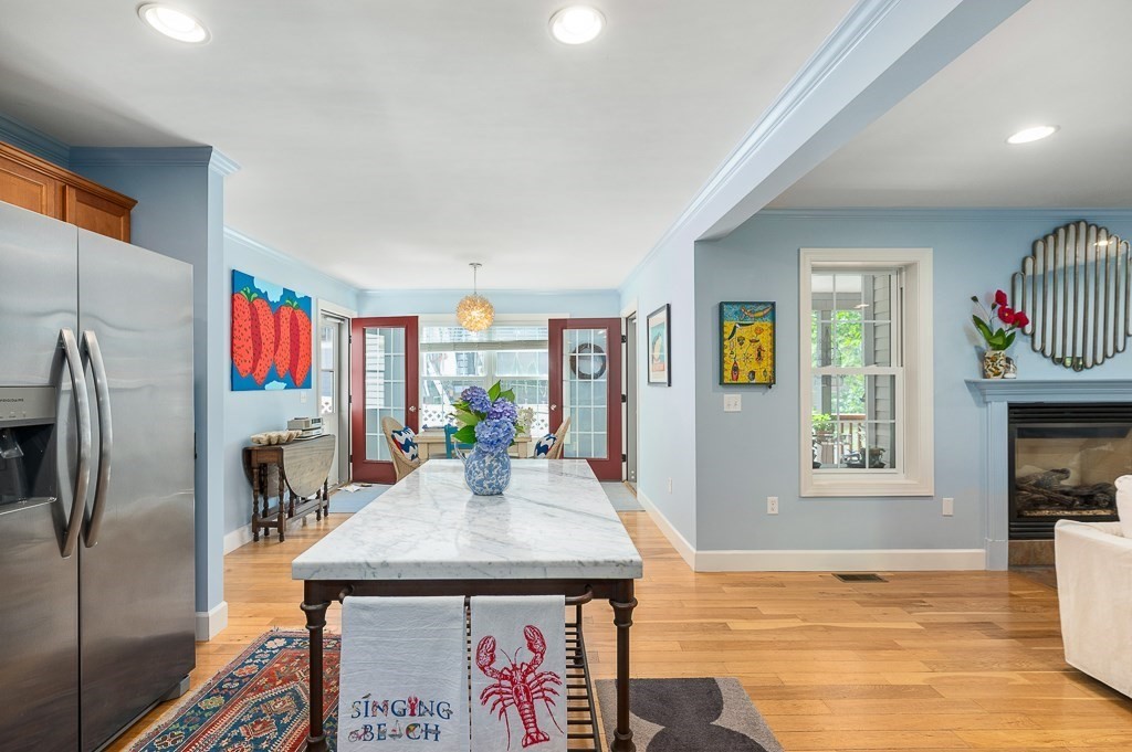 56 Summer Street, Unit A Manchester, MA 01944 - Photo 12 of 35 a view of a kitchen area with furniture and wooden floor