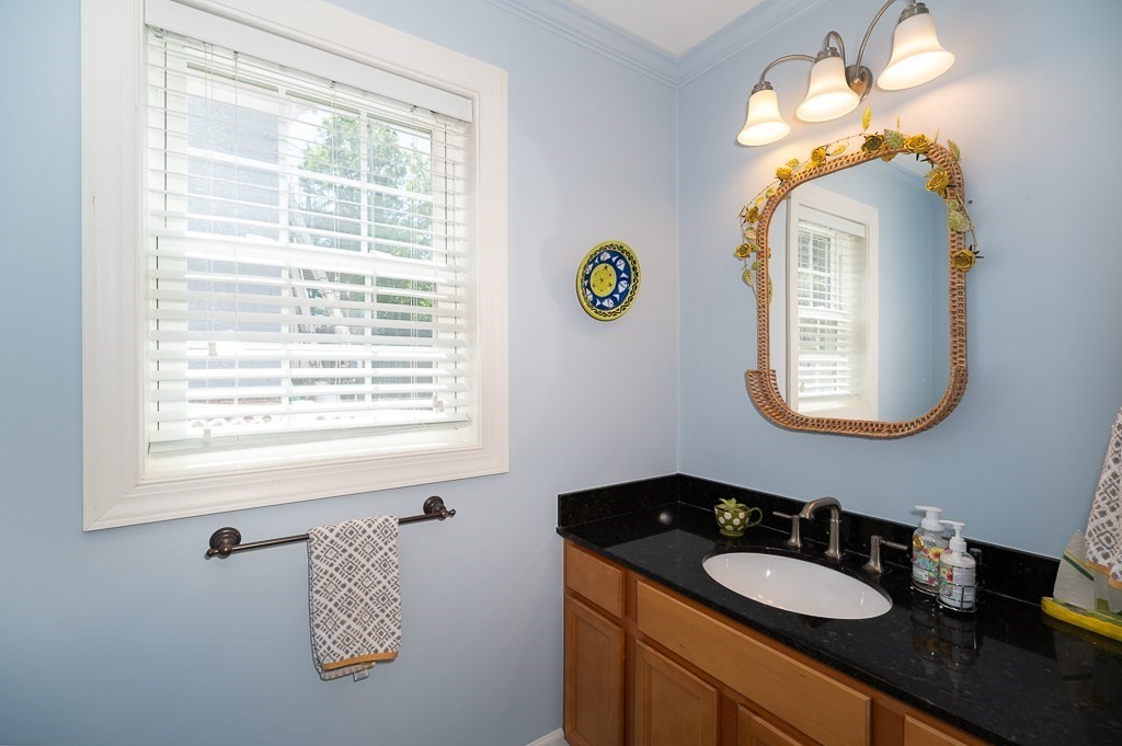 56 Summer Street, Unit A Manchester, MA 01944 - Photo 14 of 35 a bathroom with a sink and a mirror