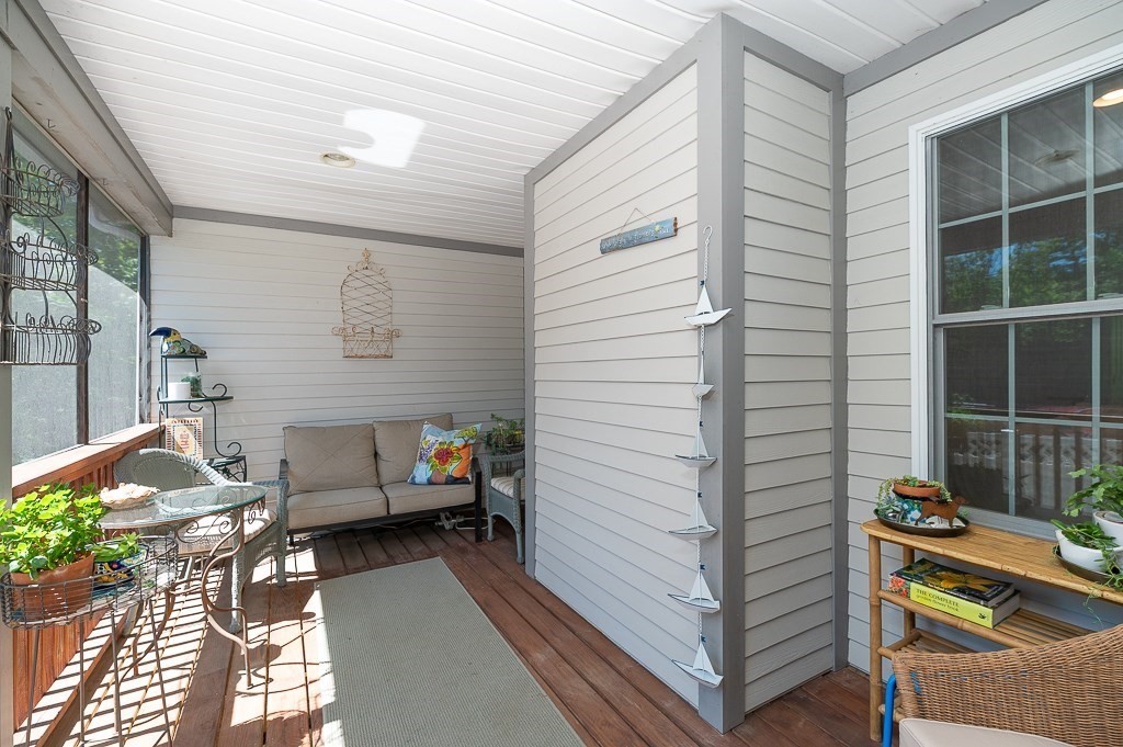56 Summer Street, Unit A Manchester, MA 01944 - Photo 15 of 35 a view of a patio with a table and chairs and potted plants