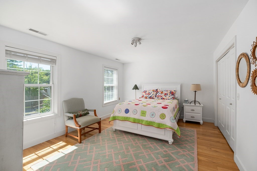 56 Summer Street, Unit A Manchester, MA 01944 - Photo 16 of 35 a bedroom with furniture and a window