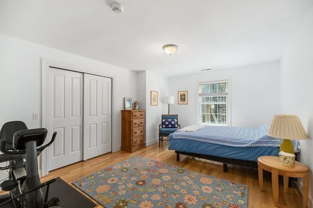 a bedroom with a bed and a chair