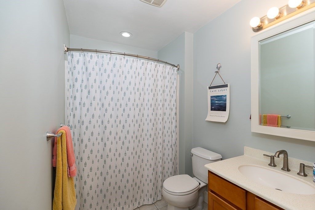 56 Summer Street, Unit A Manchester, MA 01944 - Photo 18 of 35 a bathroom with a sink a toilet and a mirror