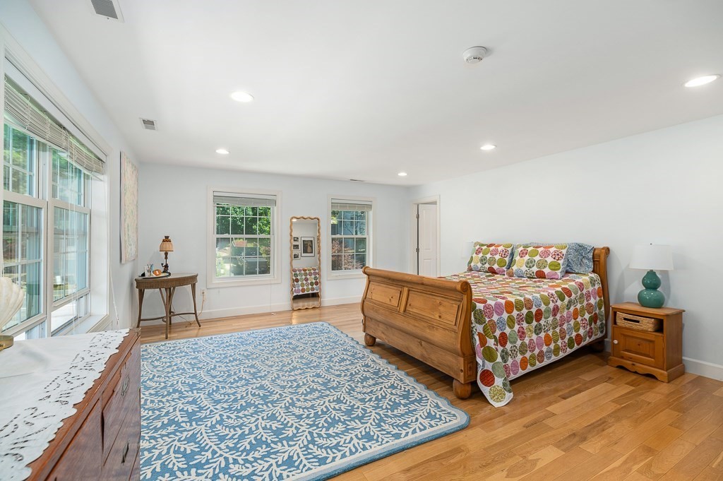 56 Summer Street, Unit A Manchester, MA 01944 - Photo 21 of 35 a bed room with a bed and a couch