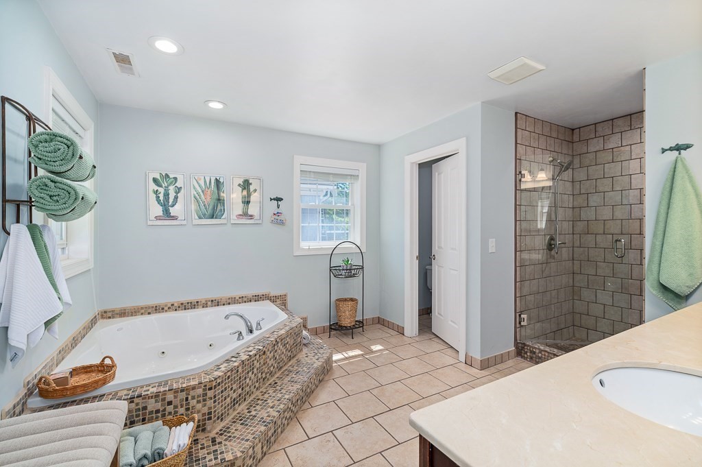 56 Summer Street, Unit A Manchester, MA 01944 - Photo 23 of 35 a bathroom with a tub a sink and a shower