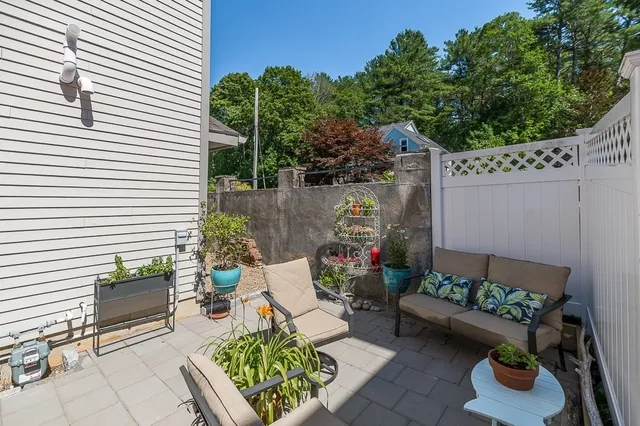 a view of a patio with couches table and chairs and potted plants