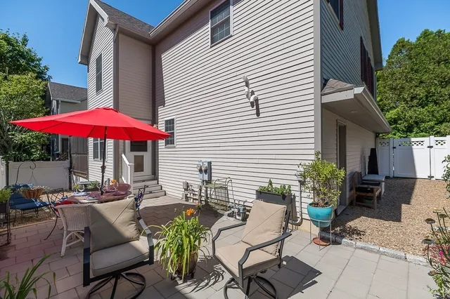 an outdoor space with patio and white umbrellas