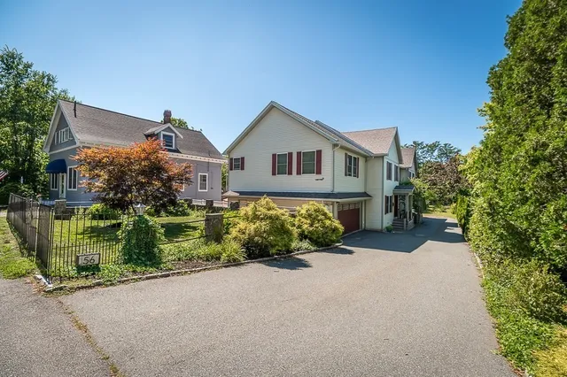 a front view of a house with a garden