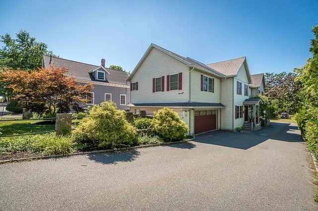 a front view of a house with a garden and yard
