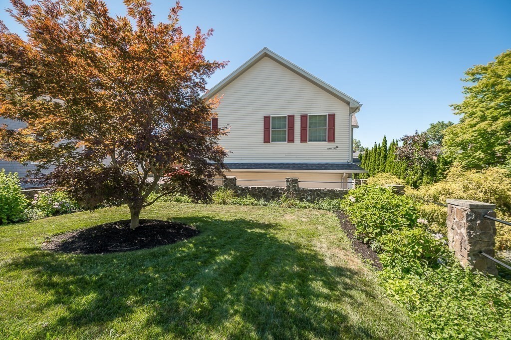56 Summer Street, Unit A Manchester, MA 01944 - Photo 31 of 35 a house with a big yard and large trees
