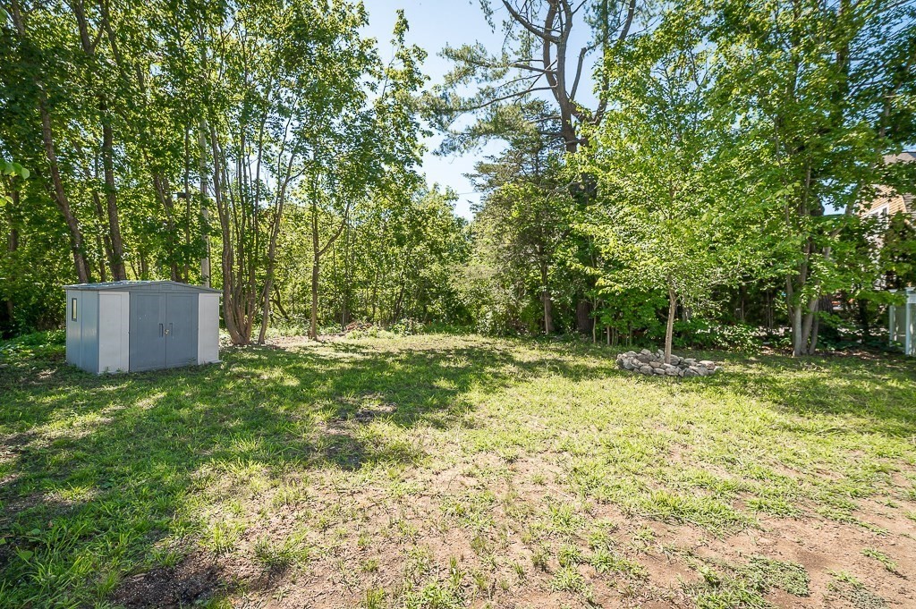 56 Summer Street, Unit A Manchester, MA 01944 - Photo 33 of 35 a backyard of a house with lots of green space