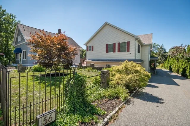 a front view of a house with a garden