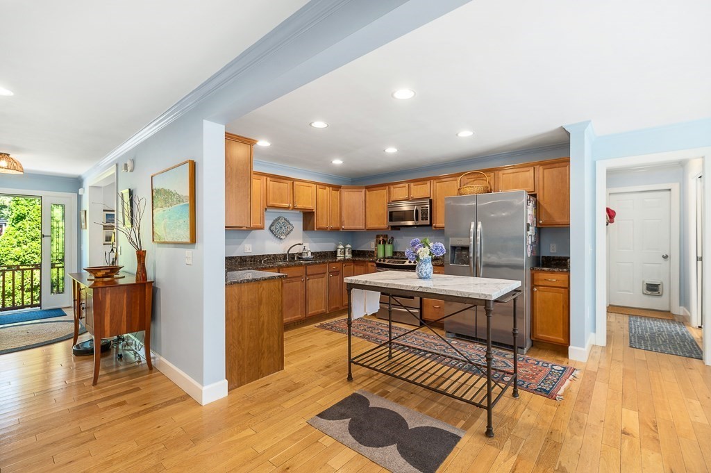 56 Summer Street, Unit A Manchester, MA 01944 - Photo 10 of 35 a living room with stainless steel appliances kitchen island granite countertop furniture and a wooden floor