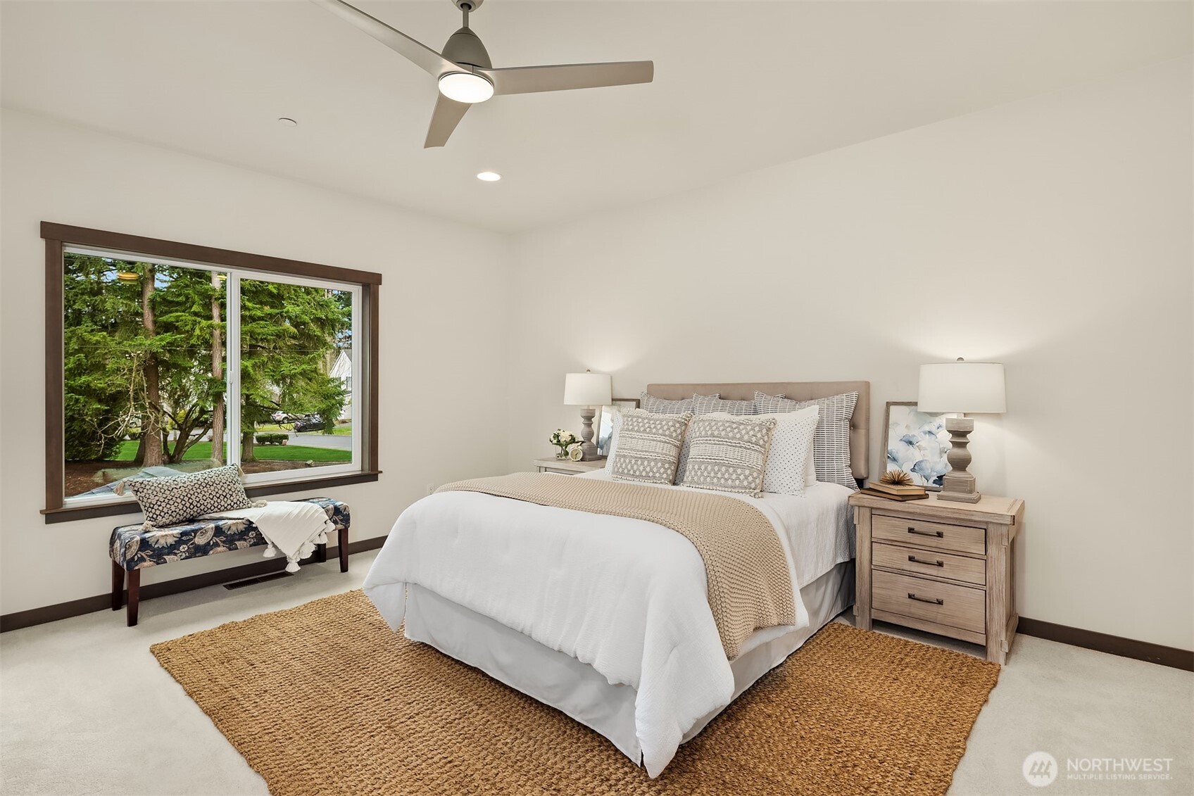9207 Northeast 175th Street, Unit A Bothell, WA 98011 - Photo 18 of 38 a bedroom with a bed a couch and a window
