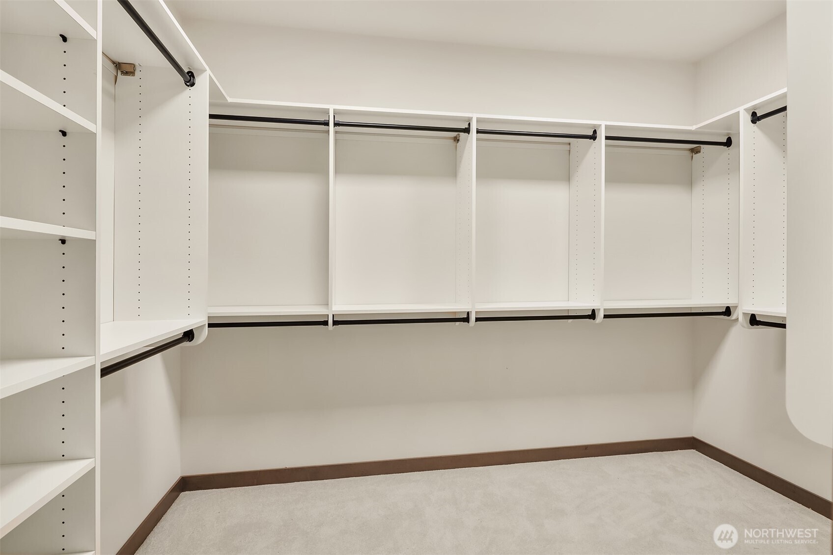 9207 Northeast 175th Street, Unit A Bothell, WA 98011 - Photo 23 of 38 a view of walk in closet with empty racks