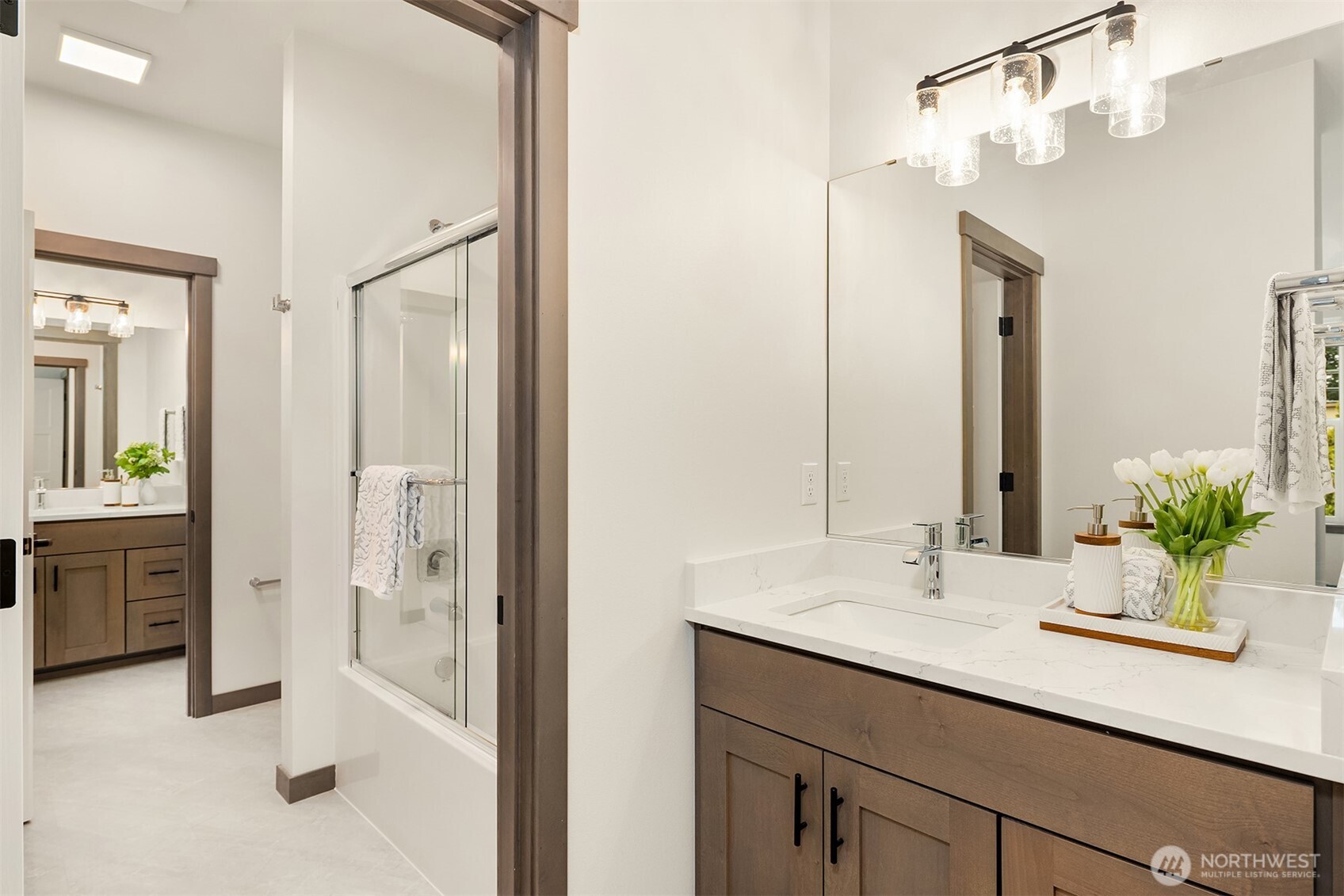 9207 Northeast 175th Street, Unit A Bothell, WA 98011 - Photo 26 of 38 a bathroom with a sink double vanity and a shower