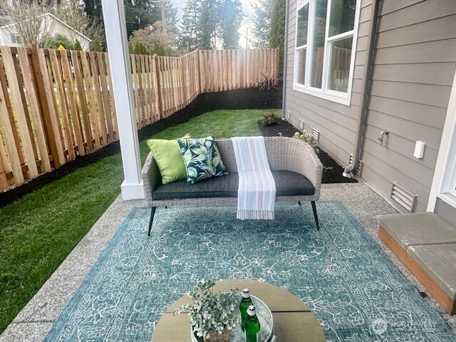 9207 Northeast 175th Street, Unit A Bothell, WA 98011 - Photo 29 of 38 a view of a back yard of the house with a chairs and bench in the patio