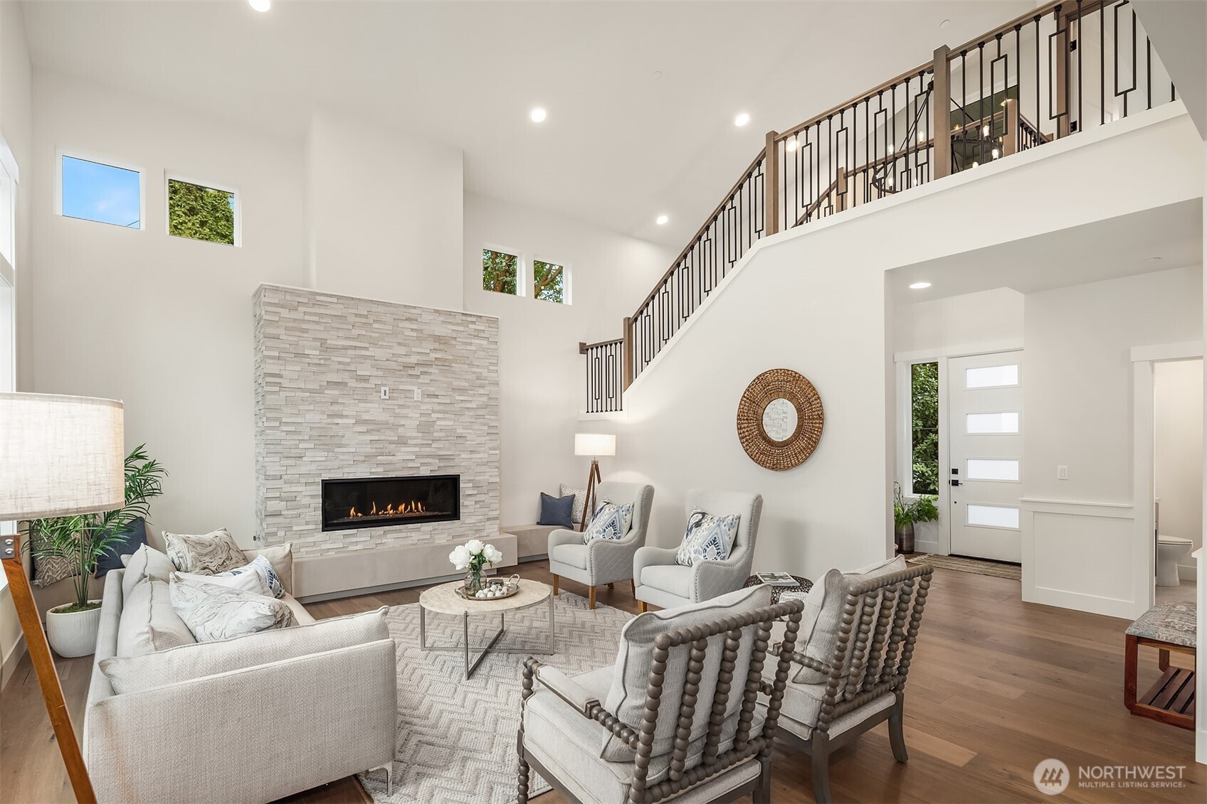 9207 Northeast 175th Street, Unit A Bothell, WA 98011 - Photo 6 of 38 a living room with furniture a fireplace and a clock