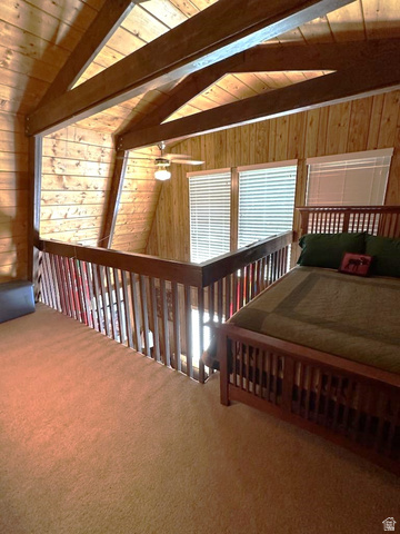 1456 Navajo Road Coalville, UT 84017 - Photo 21 of 55 Carpeted bedroom featuring wooden walls, wooden ceiling, and lofted ceiling with beams