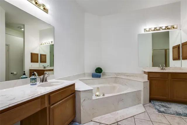 a bathroom with a bathtub sink and mirror