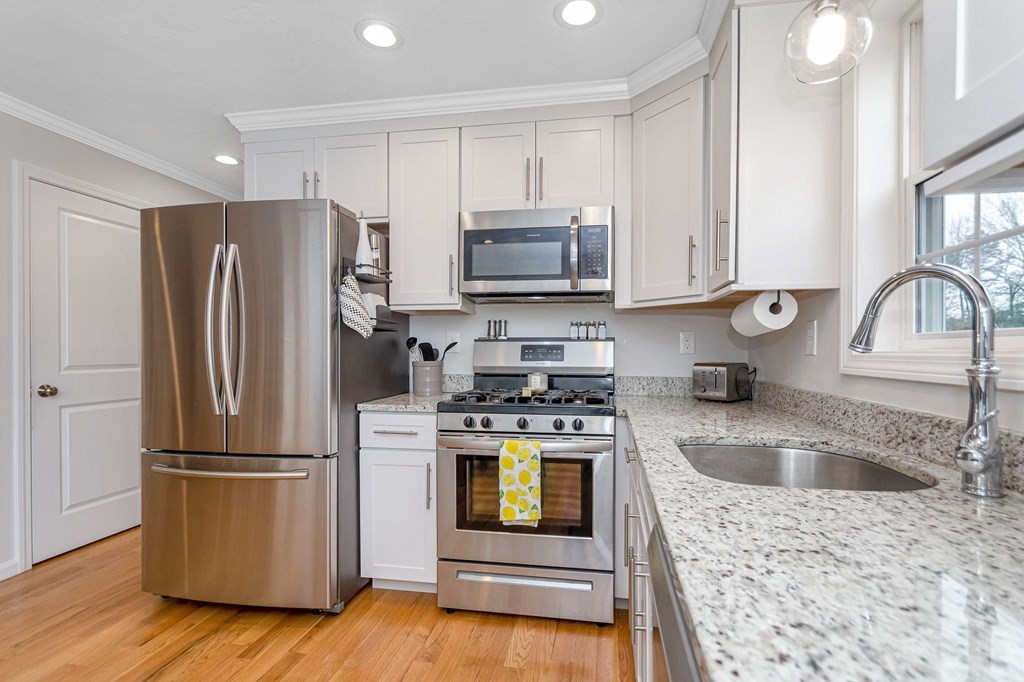 69 Riley Road, Unit 69 Tyngsboro, MA 01879 - Photo 11 of 42 a kitchen with a refrigerator sink and stove