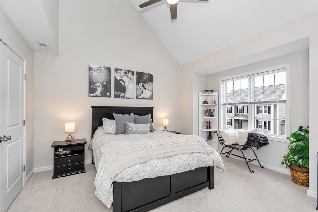 69 Riley Road, Unit 69 Tyngsboro, MA 01879 - Photo 17 of 42 a bedroom with a large bed and potted plant
