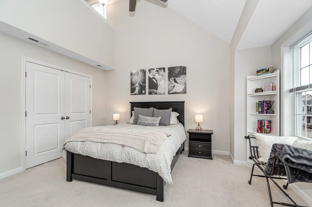 69 Riley Road, Unit 69 Tyngsboro, MA 01879 - Photo 19 of 42 a bedroom with a bed and a bookshelf