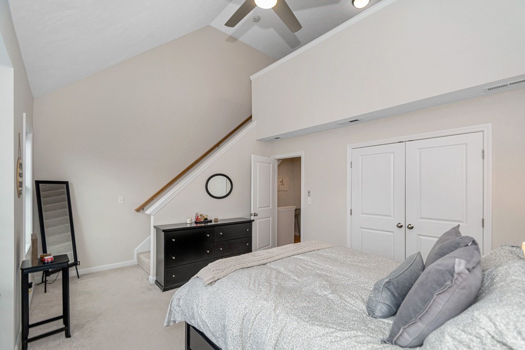 69 Riley Road, Unit 69 Tyngsboro, MA 01879 - Photo 20 of 42 a bedroom with a bed and a chandelier