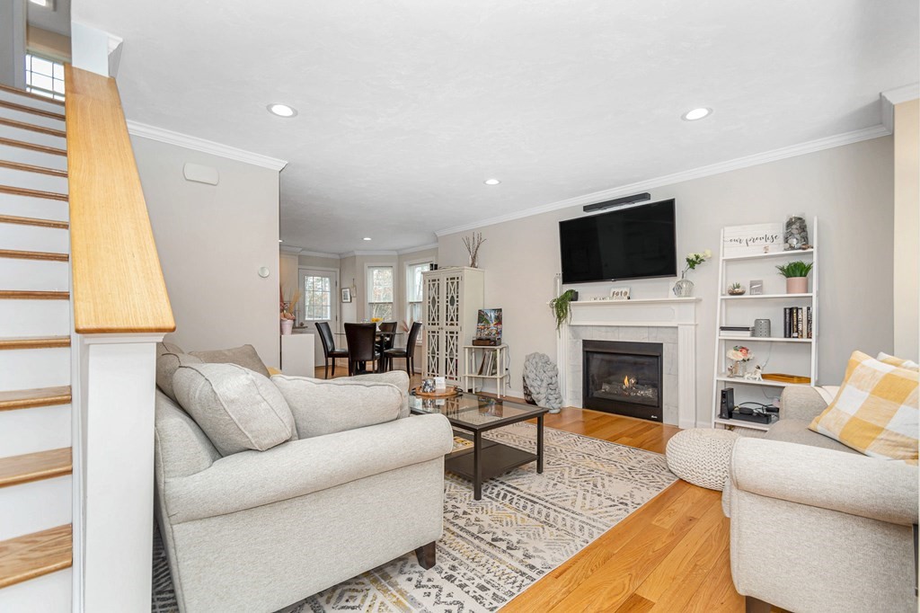 69 Riley Road, Unit 69 Tyngsboro, MA 01879 - Photo 2 of 42 a living room with furniture a fireplace and a flat screen tv