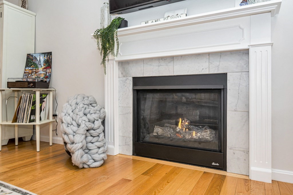 69 Riley Road, Unit 69 Tyngsboro, MA 01879 - Photo 26 of 42 a living room with a fireplace