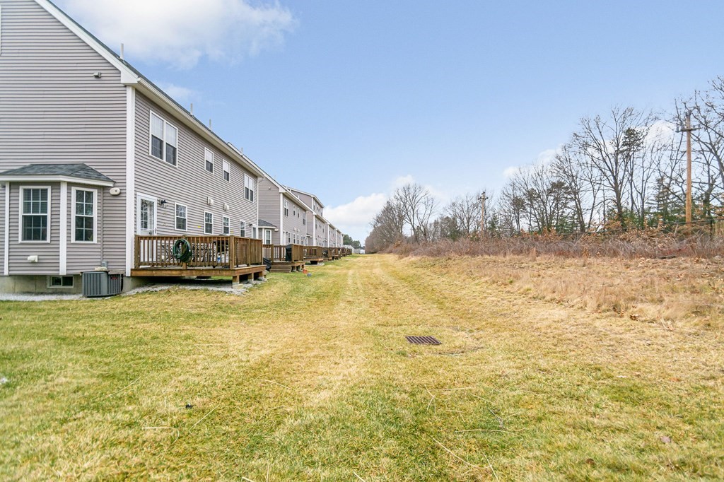 69 Riley Road, Unit 69 Tyngsboro, MA 01879 - Photo 32 of 42 a view of a house with a yard