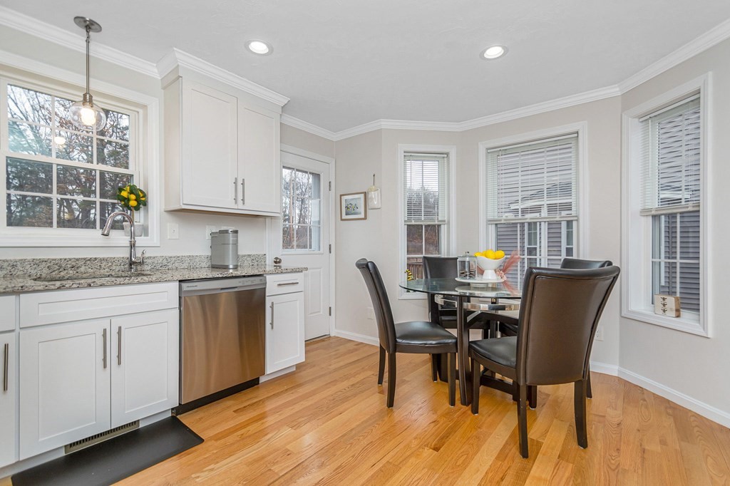 69 Riley Road, Unit 69 Tyngsboro, MA 01879 - Photo 8 of 42 a view of a dining room with furniture and wooden floor