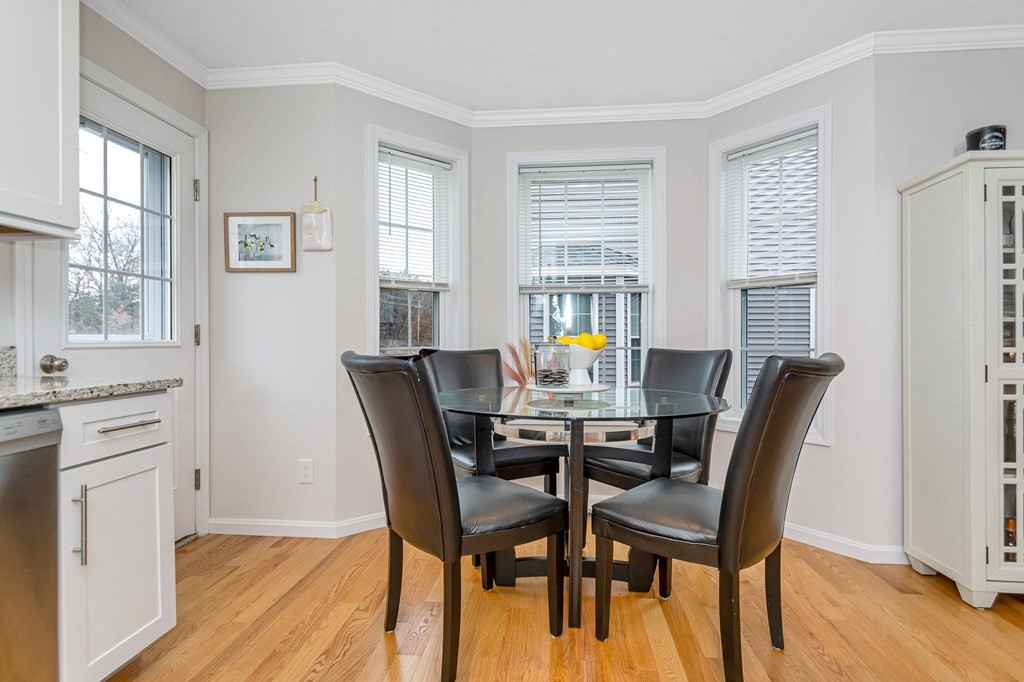 69 Riley Road, Unit 69 Tyngsboro, MA 01879 - Photo 9 of 42 a view of a dining room with furniture and wooden floor