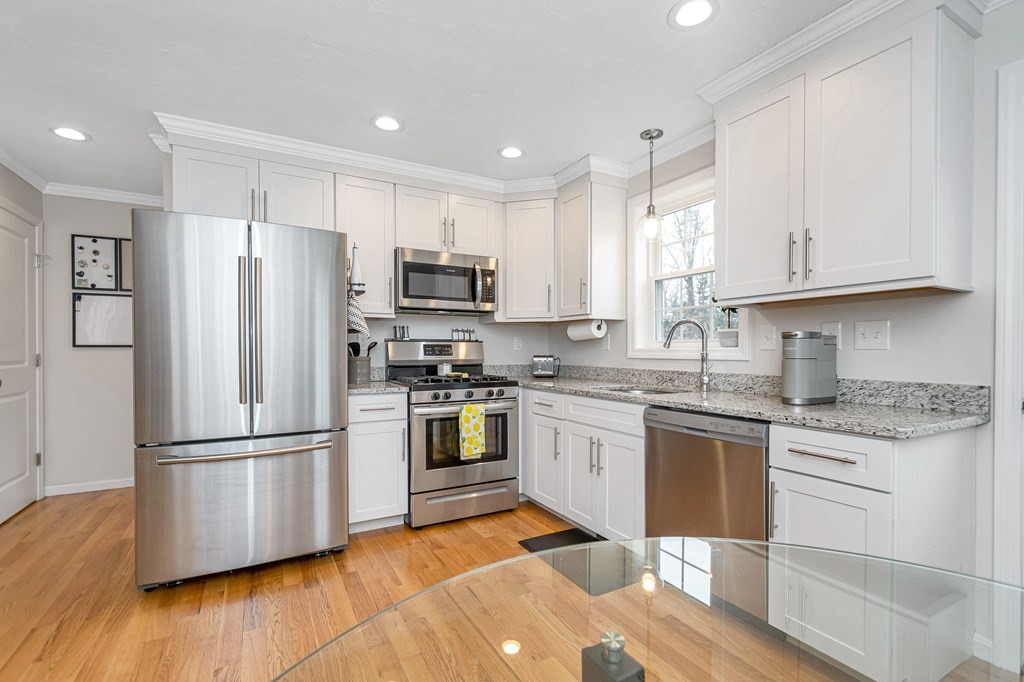 69 Riley Road, Unit 69 Tyngsboro, MA 01879 - Photo 10 of 42 a kitchen with stainless steel appliances granite countertop a refrigerator stove microwave and sink