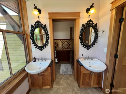 a bathroom with a sink a mirror and a shower